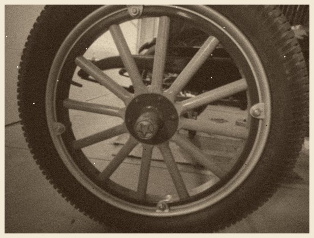 Wood-spoke (artillery) wheel in natural finish with a star-emblem hub cap